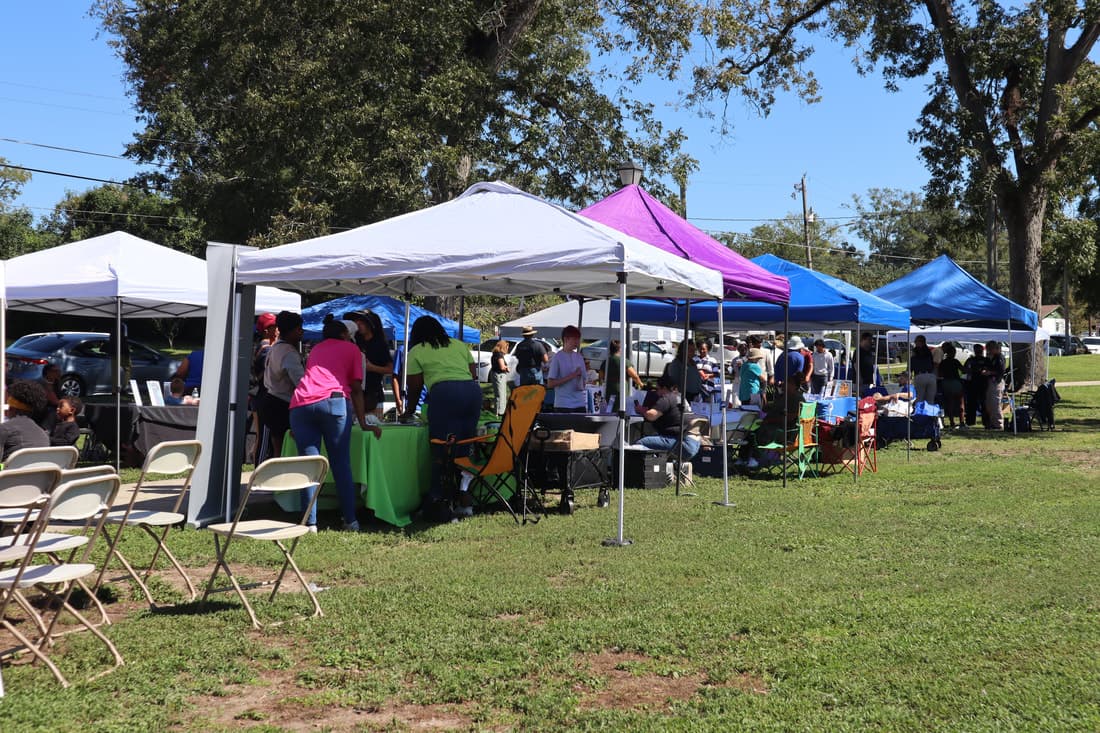 Outdoor vendor and community setup at a DRMI event.